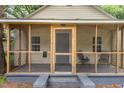 Cozy screened porch with seating area providing a relaxing outdoor space at the front of the home at 611 Rowland St, Henderson, NC 27536
