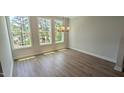 Dining room with hardwood floors and a picturesque view from large windows at 691 Bandon Aly, Cary, NC 27513