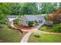 Exterior shows yard featuring winding stone walkway, lush greenery, and multiple structures at 708 October Woods Rd, Chapel Hill, NC 27516