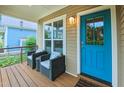 Inviting front porch with seating, perfect for enjoying the outdoors and a bright blue door at 729 Lorentello Cir, Hillsborough, NC 27278