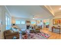 Bright living room featuring hardwood floors, fireplace, ceiling fan and an open floor plan at 729 Lorentello Cir, Hillsborough, NC 27278