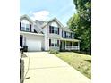 A two-story house with a front porch and a two-car garage connected by a driveway at 75 Mountainside Ln, Sanford, NC 27332
