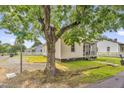 Street view of home showing mature tree, screened porch and front yard at 804 Delaware Ave, Burlington, NC 27217
