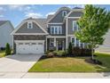 Charming two-story home with a stone-accented garage and neatly manicured front lawn at 808 Buckner Ct, Fuquay Varina, NC 27526