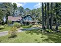 Charming two-story home with a spacious front yard and a long driveway surrounded by mature trees at 8156 Nc 42 Hwy W, Kenly, NC 27542