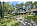 Charming two-story home with beautiful landscaping, a welcoming front porch, and long driveway lined by mature trees at 8156 Nc 42 Hwy W, Kenly, NC 27542