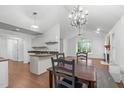 Open concept dining room featuring an elegant chandelier, vaulted ceilings, and a connection to the living room at 100 Culbreth Rd # C, Chapel Hill, NC 27516