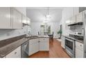 Modern kitchen with stainless steel appliances, granite countertops, and white cabinetry, offering ample space at 100 Culbreth Rd # C, Chapel Hill, NC 27516
