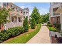Attractive townhome exteriors with landscaped walkway, front steps, and private porches at 10310 Sablewood Dr # 111, Raleigh, NC 27617