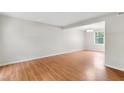 Bright living room featuring hardwood floors, a neutral color palette, and natural light from a large window at 104 Benedict Ln, Raleigh, NC 27614