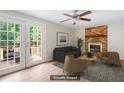 Cozy living room with a brick fireplace, comfortable seating, and bright natural light at 104 Benedict Ln, Raleigh, NC 27614