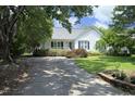 Inviting home featuring a front porch, charming shutters, and mature landscaping at 109 Perry Farms Dr, Apex, NC 27502