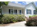 Charming front porch with white railings, blue shutters and a cozy atmosphere at 109 Perry Farms Dr, Apex, NC 27502