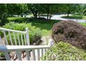 Beautifully landscaped front yard with mature trees and a well-manicured lawn at 109 Perry Farms Dr, Apex, NC 27502