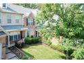 Aerial view of townhomes with manicured lawns and mature trees offering a serene setting at 11217 Maplecroft Ct, Raleigh, NC 27617