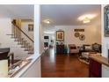 Inviting living room with hardwood floors, staircase, and cozy seating area at 11217 Maplecroft Ct, Raleigh, NC 27617