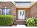 Close up of home's front door and brick facade at 1209 Waterford Green Dr, Apex, NC 27502