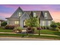 Beautiful craftsman-style home with stone accents, a well-manicured lawn, and mature trees showcasing curb appeal at 1342 Briar Chapel Pkwy, Chapel Hill, NC 27516