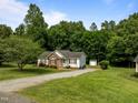 Ranch-style home on a large lot with a long driveway and mature trees at 1383 Deercroft Ct, Graham, NC 27253