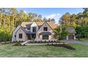 Beautiful exterior elevation of a stone home on a lush, green lot with mature landscaping at 15517 Possum Track Rd, Raleigh, NC 27614