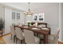 Warm dining room setup with table settings, linen curtains, and framed artwork at 1817 Wysong Ct, Raleigh, NC 27612