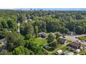 Aerial view of property in a lush, green neighborhood with city skyline in the distance at 1818 Cecil St, Durham, NC 27707