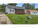 Quaint home with a screened front porch, mailbox and lush lawn, perfect for curb appeal at 1818 Cecil St, Durham, NC 27707