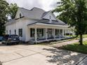 Well-maintained house boasts a covered front porch and a long driveway for ample parking at 212 W Church St, Benson, NC 27504