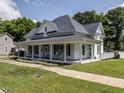 Beautiful two-story home with a spacious wraparound porch, perfect for enjoying the outdoors at 212 W Church St, Benson, NC 27504
