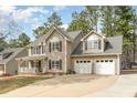 Charming two-story home featuring a covered front porch and a two-car garage at 216 Captain Harbor Hbr, Sanford, NC 27332
