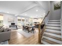Open-concept living space with dining area, kitchen, staircase, and hardwood floors at 226 Castle Pond Way, Fuquay Varina, NC 27526