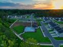 Beautiful aerial view of a new neighborhood with pool and community amenities at sunset at 267 Meadowbark Bnd # 34, Garner, NC 27529