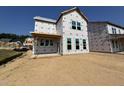 Under-construction two-story home featuring window framing and exterior wall wrap, showing the layout and design at 267 Meadowbark Bnd # 34, Garner, NC 27529