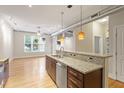 Open kitchen featuring stainless steel appliances, granite countertops, and natural light, overlooking living area at 300 Finsbury St # 109, Durham, NC 27703
