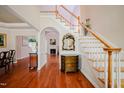 Inviting foyer with hardwood floors, staircase, and elegant decorative mirror at 3021 Glenwood Dr, Durham, NC 27705