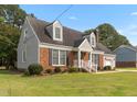 Well-maintained home with a brick facade, dormer windows, green lawn and mature landscaping at 304 Westfield Dr, Dunn, NC 28334