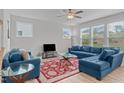 Comfortable living room with plush blue seating, patterned rug, and a modern glass coffee table at 309 Highland Forest Dr, Fuquay Varina, NC 27526