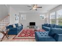Inviting living room with two plush blue sofas, hardwood floors, and bright natural light at 309 Highland Forest Dr, Fuquay Varina, NC 27526