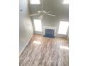 Bright open-concept living area with fireplace, ceiling fan, and attractive laminate flooring at 3207 Geary Trl, Raleigh, NC 27610