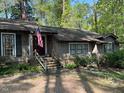 Inviting exterior of home with brick accents, a cozy front porch, and beautifully landscaped front yard at 36A Country Club Dr, Rocky Mount, NC 27804