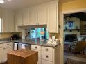 Bright kitchen featuring a breakfast bar pass-through, granite countertops, and ample cabinet space at 36A Country Club Dr, Rocky Mount, NC 27804