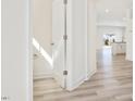 Bright hallway leading to an open kitchen with modern cabinets and appliances at 425 Hipwood Dr, Zebulon, NC 27597