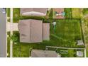 Birds-eye view of backyard with lush lawn, swing set, privacy fence, and neighboring homes at 542 Spaulding St, Burlington, NC 27215