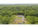 Overhead view of charming home surrounded by a lush forest, showcasing a serene and private setting at 5550 Mountain Trl, Snow Camp, NC 27349