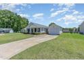 Inviting one-story home featuring an attached garage, complemented by a well-maintained lawn at 6 N Carolina Ave, Benson, NC 27504