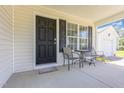 Cozy front porch featuring a table and chairs, ideal for relaxing outdoors and enjoying the view at 6 N Carolina Ave, Benson, NC 27504