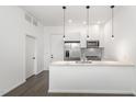 Contemporary kitchen featuring stainless steel appliances, white cabinetry, and a large kitchen island at 600 S Duke St # 24, Durham, NC 27701