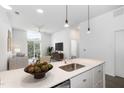 Modern kitchen with island and stainless steel appliances, with living room in the background at 600 S Duke St # 24, Durham, NC 27701
