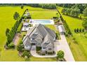 Expansive aerial view of the property highlighting the pool, outdoor amenities, and meticulous landscaping at 6250 Moinear Ln, Chapel Hill, NC 27514