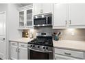 Stylish kitchen featuring white cabinets, stainless steel appliances, and a tiled backsplash at 6313 Kayton St, Raleigh, NC 27616